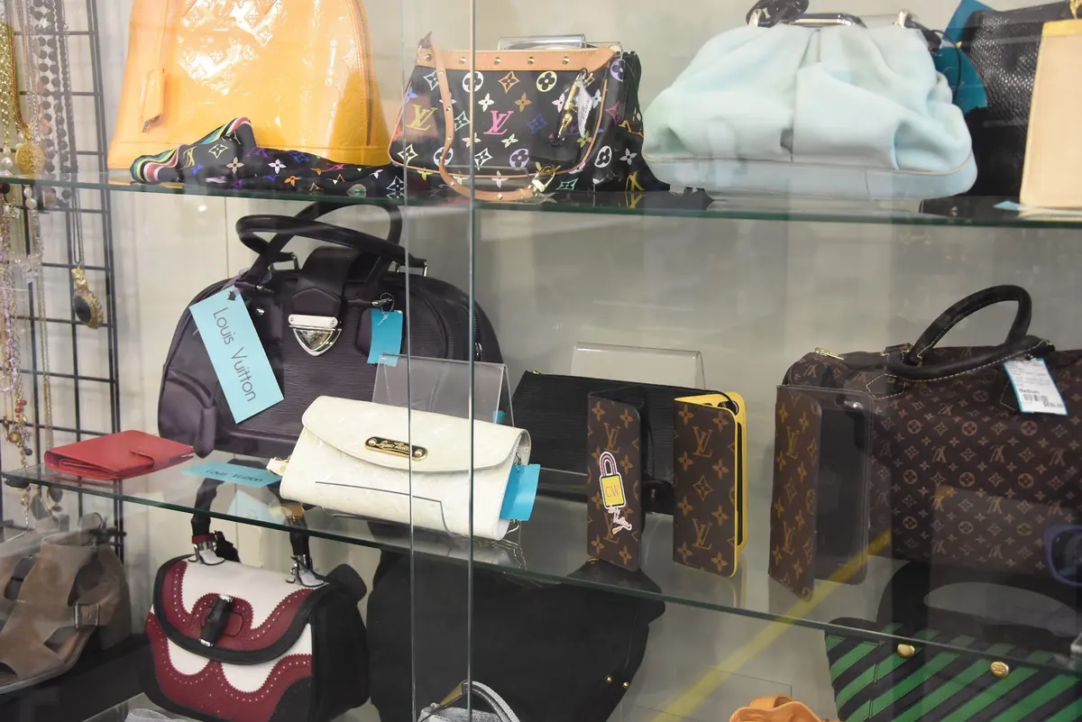 Designer handbags in a glass display case