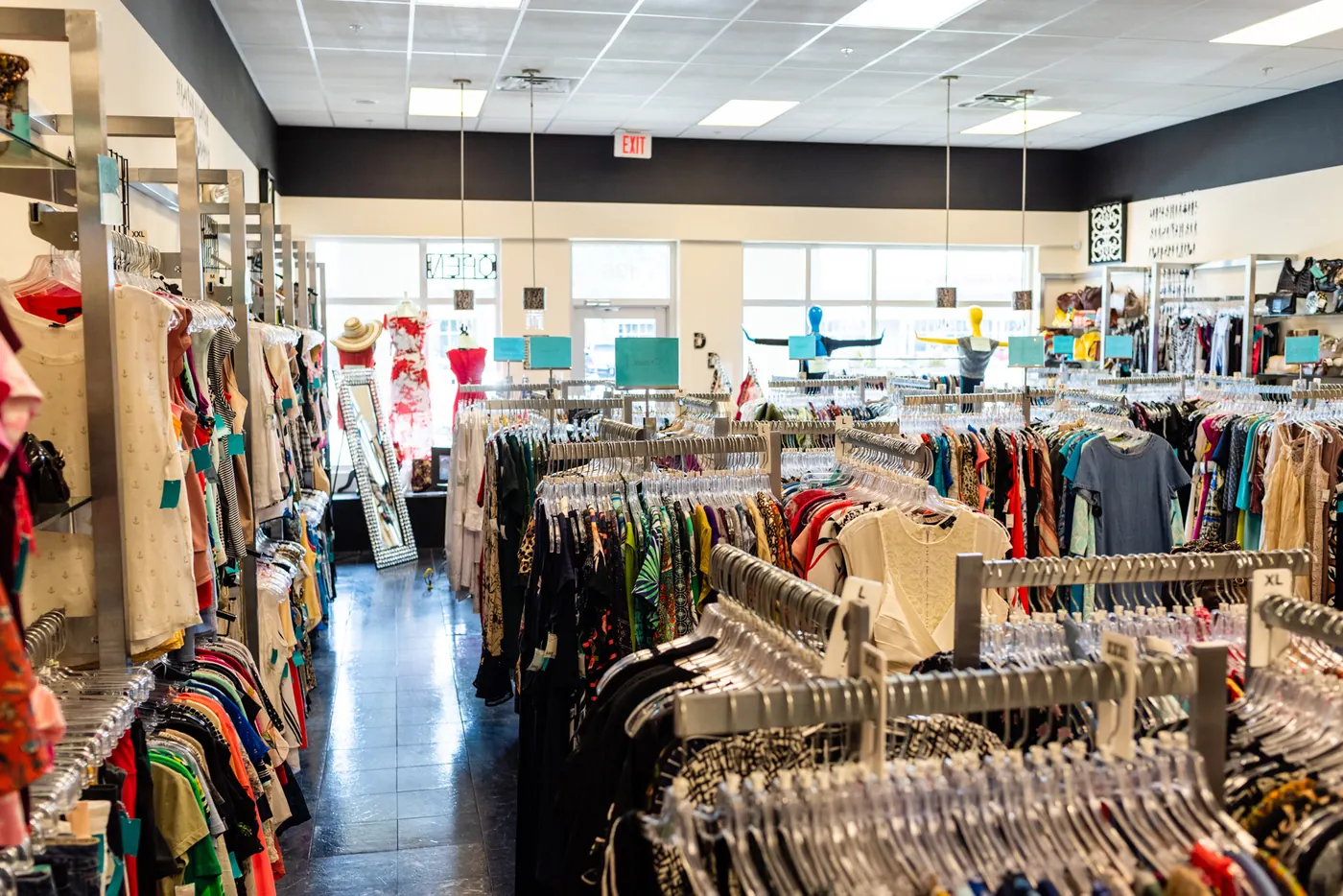 Racks of clothing in a bright, organized store